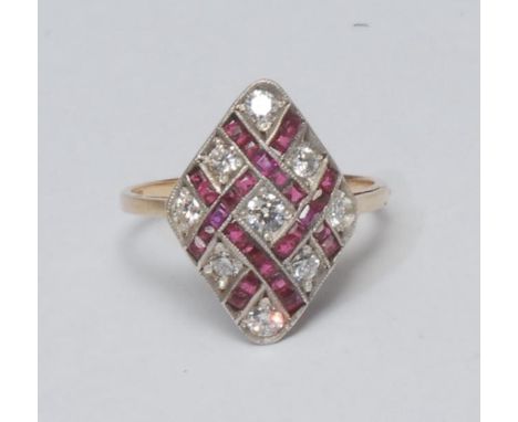 A diamond and ruby lattice top dress ring, woven diamond shaped crest inset with nine round brilliant cut diamonds within rub
