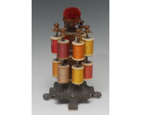 A Victorian mahogany and cast iron  two tier cotton reel stand,  pin cushion finial, the base cast with acanthus leaves, paw 