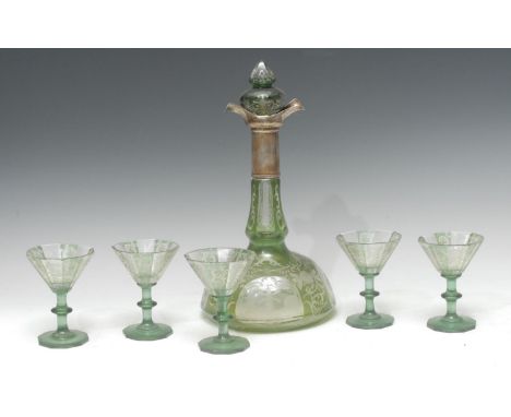 An early 20th century Bohemian green overlaid decanter and glasses, engraved with four oval cartouches with windmills, the gr