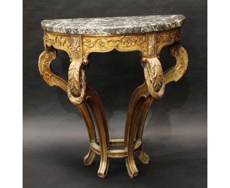 A 19th century giltwood demilune console table, veined marble top above a deep frieze carved with leafy scrolls, bosses and s