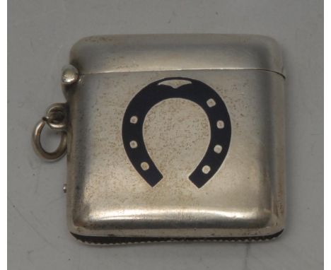 A late Victorian novelty silver and enamel rounded square vesta case, decorated in dark blue enamel with a horseshoe, 4.1cm l