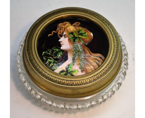 An Art Nouveau period Limoges enamel mounted powder bowl, the cover with inset panel decorated in polychrome with a young bac