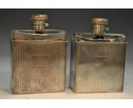 A pair of George V silver slip-cased flasks, hinged domed covers, engine turned in bands, 12.5cm high, Samuel Jacob, London 1