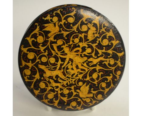 A 19th century Renaissance Revival black papier-mâché circular table-top snuff box, painted in gilt with a huntsman and his h