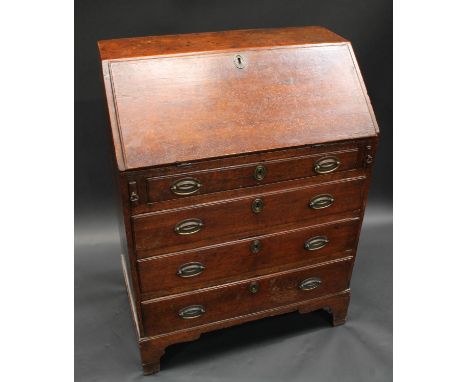 A George III oak bureau, of narrow proportions, fall front enclosing pigeonholes and small drawers above four long graduated 