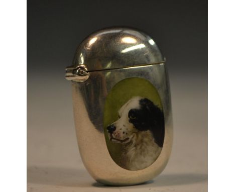 A Victorian silver and enamel rounded rectangular novelty vesta case, decorated with a spaniel dog, hinged cover, striker to 