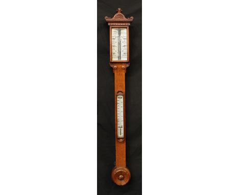 A Victorian oak stick barometer, the rectangular register marked J.Hicks, London, demilune floral cresting capped and flanked