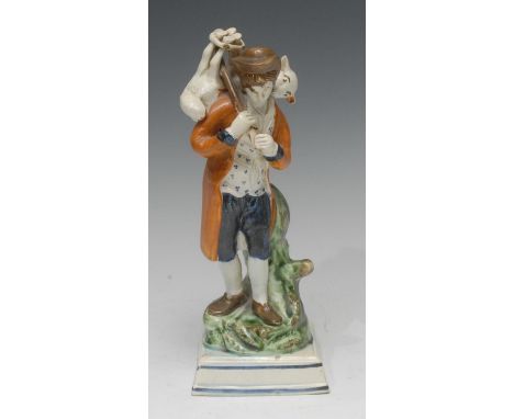 A Staffordshire Pearl Ware figure, The Lost Sheep Found, the shepherd wears a mottled blue coat and carries a lamb on his bac