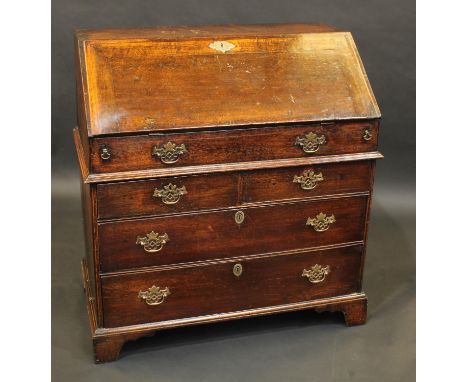 A George II oak bureau, fall front enclosing a stepped interior with well, above two short and two long graduated drawers, pi