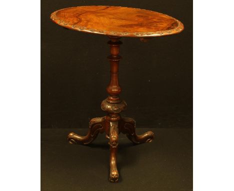 A Victorian walnut tripod occasional table, well figured oval top, turned pillar, carved throughout with leafy borders, cabri