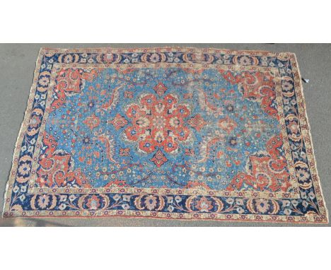 A Middle Eastern woollen carpet, in traditional tones of red and blue, with a geometrical patterns, 362cm x 236cm