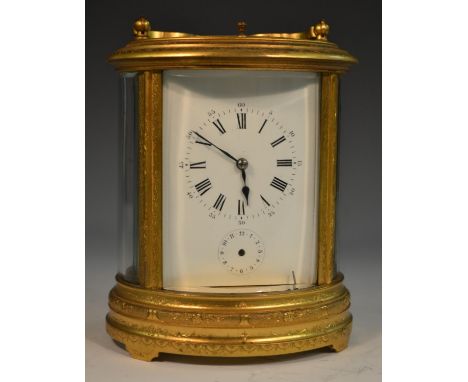 A 19th century oval repeater carriage clock, Roman numerals, subsidiary dial, engraved with foliage, shaped handle, 21cm high