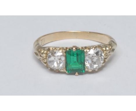 A vibrant green emerald and diamond trilogy ring, central certified Columbian octagonal cut emerald approx 0.70ct, flanked ei