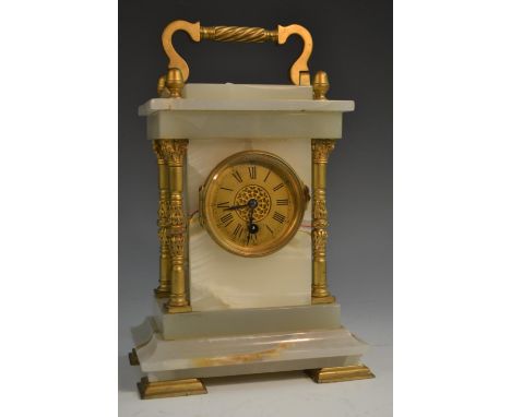 An early 20th century  onyx carriage clock, with Roman numerals, the case with gilt metal freestanding pillars, bracket feet,