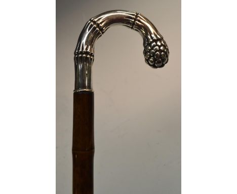 A German gentleman's silver and bamboo walking stick, the naturalistic crook-shaped handle as sprouting bamboo, brass walking