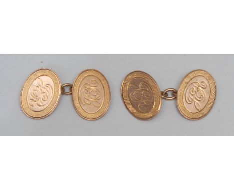 A pair of oval 9ct rose gold cufflinks, central engraved initialled panel within engine turned surround, 8.3g gross, cased