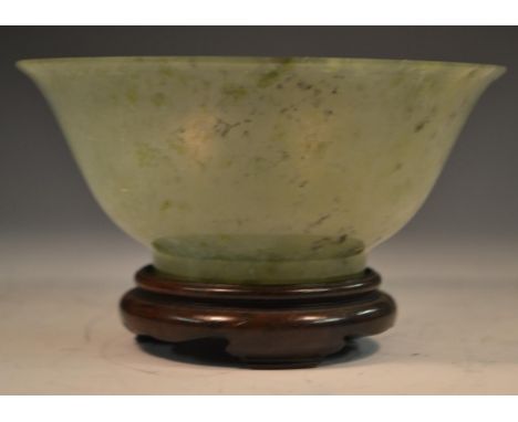 A Chinese green jade flared circular bowl, quite plain, 12.5cm diam, hardwood stand 