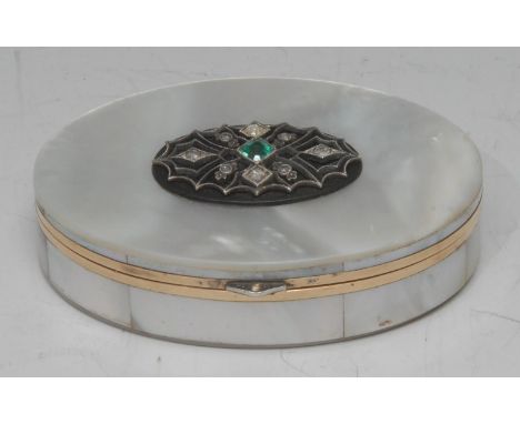 An Art Deco emerald and diamond set mother of pearl oval snuff box, oval mother of pearl body adorned with a panel of eight o