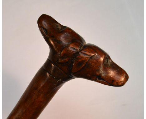 A 19th century fruitwood gentleman's novelty walking stick, the 'janus' pommel carved with two dogs' heads, 87cm long