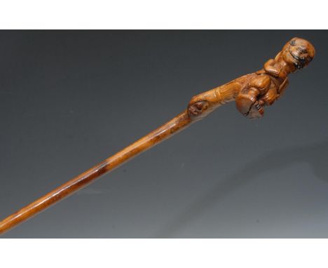 A European, possibly German Folk Art walking stick, carved with a gentleman in a medieval dress, with a large pony tail, 100c