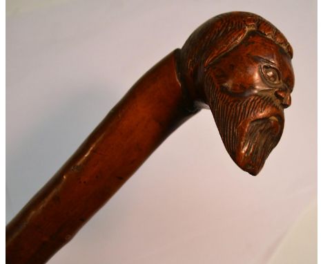 A 19th century gentleman's novelty walking stick, the pommel carved with the head of a bearded man, 82cm long