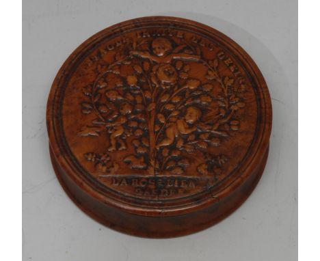 A late 18th century French burr maple and tortoiseshell circular snuff box, the titled cover pressed with amorini and a fecun