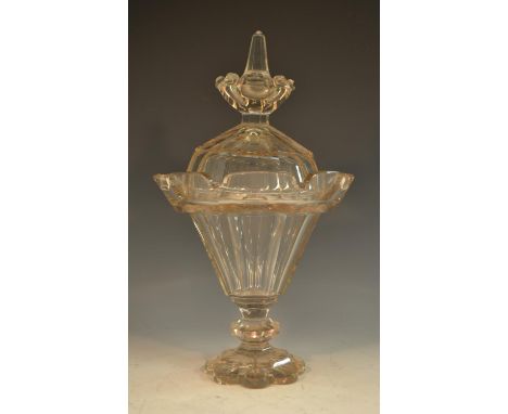 A 19th century glass lantern-shaped pedestal sweetmeat vase and cover, slightly tapering, panelled throughout, outswept crene