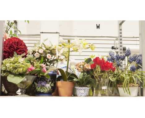 A quantity of faux floral arrangements, most contained within glass or ceramic containers to include lavender examples and ot