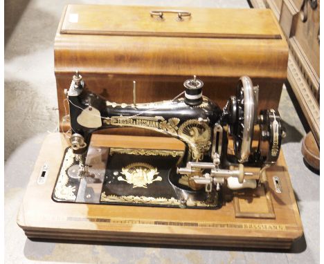 Three early 20th century cased sewing machines, comprising: a Singer, model no. E866762, a Jones, with instruction manual and
