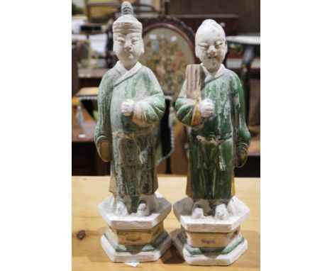 A pair of plaster/polychrome partial glazed Chinese style figures, a Chinese ceramic figure of an agricultural worker at rest