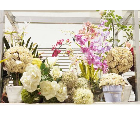 A quantity of faux floral arrangements most contained within ceramic or glass planters to include rose and orchid examples, a