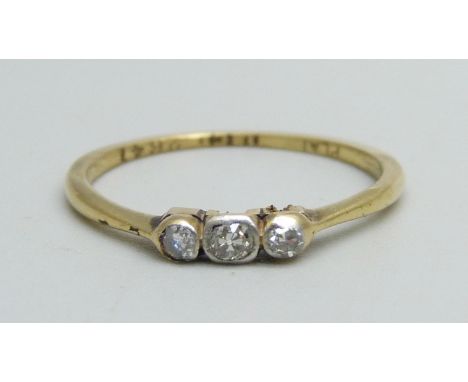 An 18ct gold, three stone diamond ring, circa 1920s, 1.5g, M, shank worn 