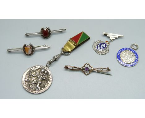 A silver St. Christopher, a silver and enamel fob medal, Notts FA Minor Competition, a silver Navy sweetheart brooch, two sil