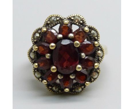 A large silver gilt, garnet and marcasite cluster ring, K 