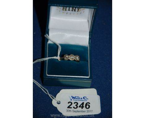 An 18ct gold platinum set three stone diamond ring