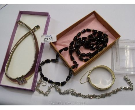 A quantity of costume jewellery including a yellow metal necklace with white stones, silver coloured necklace with white ston