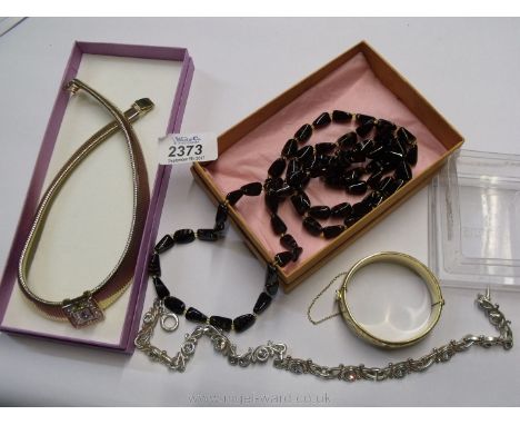 A quantity of costume jewellery including a yellow metal necklace with white stones, silver coloured necklace with white ston