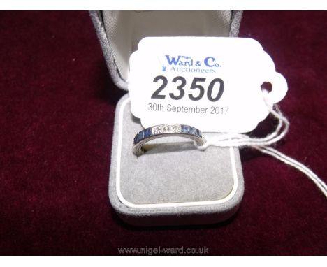 A white gold (Not hallmarked but understood to be 18ct) diamond and sapphire eternity ring