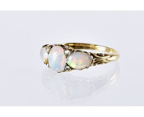 A Victorian three stone opal ring, set with rose cut diamonds and in gold mount, not marked, 4.2g and size M 