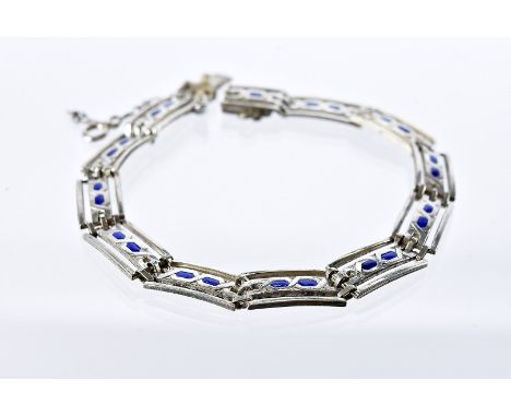 An Arts & Crafts silver and enamelled bracelet by Murrle Bennett & Co, rectangular pierced links with two blue enamel panels,