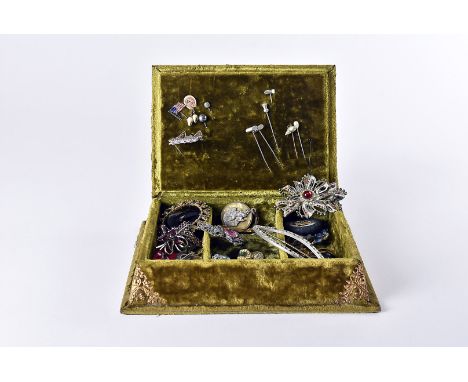 A collection of costume jewellery, including a green velvet box with Saltburn By Sea postcard lid, a carved jet brooch, a Vic