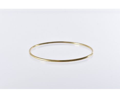 A yellow metal bangle, marked 18c, 10.5g 