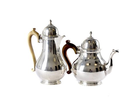 A George V silver teapot and hot water jug by RWB, retailed through Harrods, plain bulbous bodies with domed hinged lids, Lon