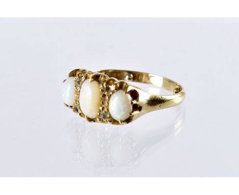 A Victorian 18ct gold and opal three stone ring, also set with four rose cut diamonds, 3.1g, with ring sizers 