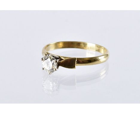 A 1970s 18ct gold and diamond solitaire engagement ring, the high claw set brilliant cut in mount marked 18ct, 2.7g and size 