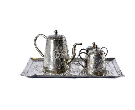 An early 20th century Indian white metal tea set, rectangular tray with teapot, sugar basin and milk jug, with lids, all with