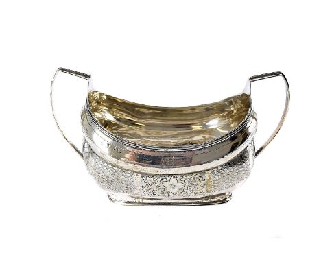 A George III period Irish silver sugar basin, boat shaped with twin handled and engraved designs, bearing family crest, marks