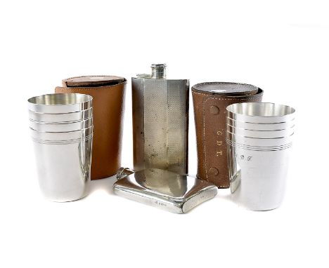 Two vintage silver hipflasks, one plain example, c1920s, and a larger engine turned example from the 1940s, together with two