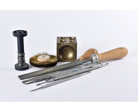 A useful collection of jewellery making and repairing equipment and other items, including a doming block, files, dental tool