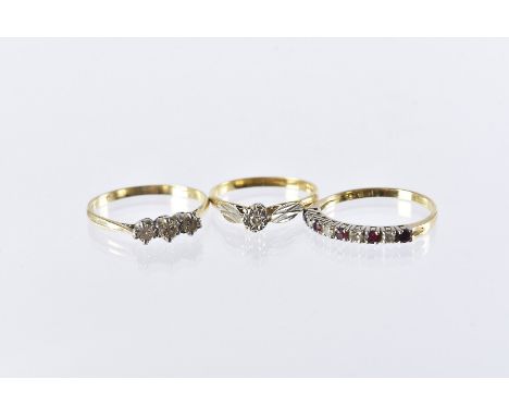 A group of three 18ct gold and gem set rings, including an Art Deco solitaire, a three stone example and a half hoop style ri